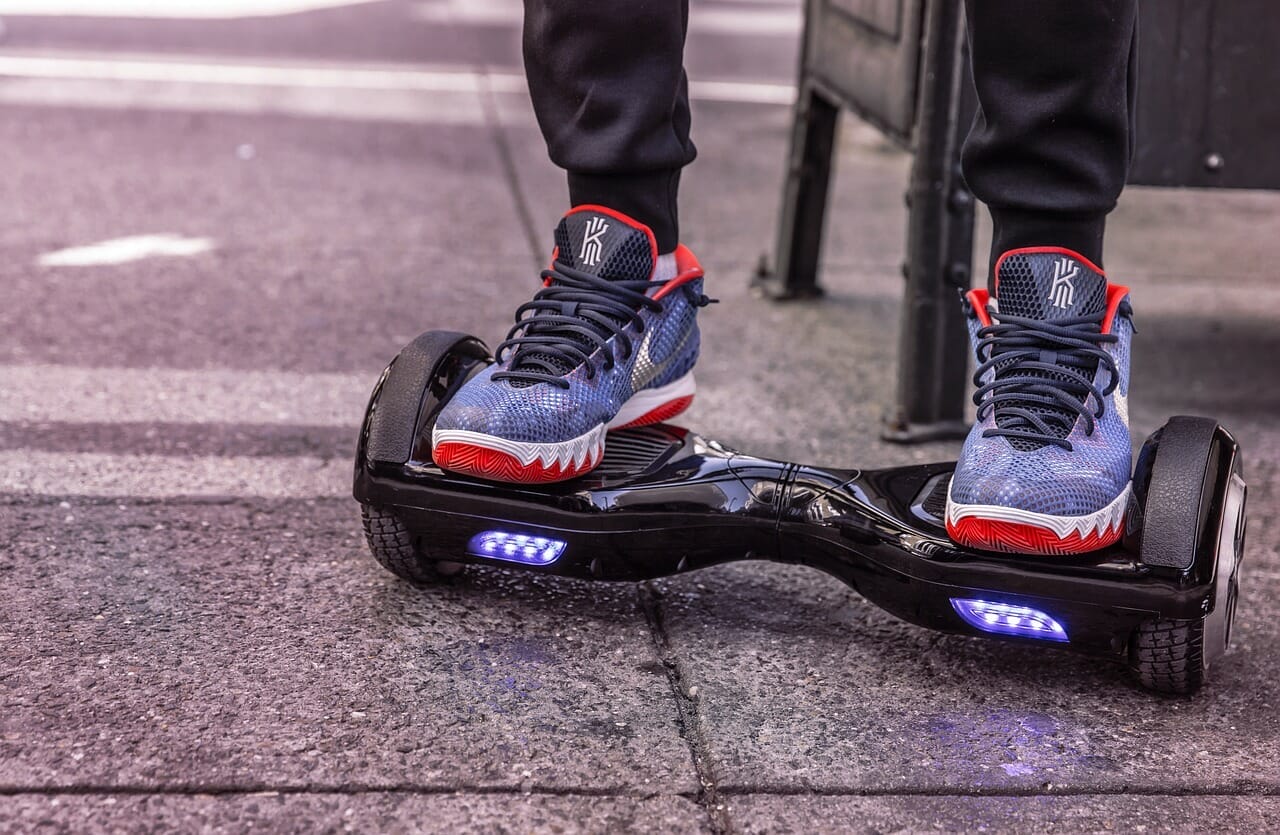 An image showcasing a hoverboard parked near a serene beach, with gentle waves caressing the shore